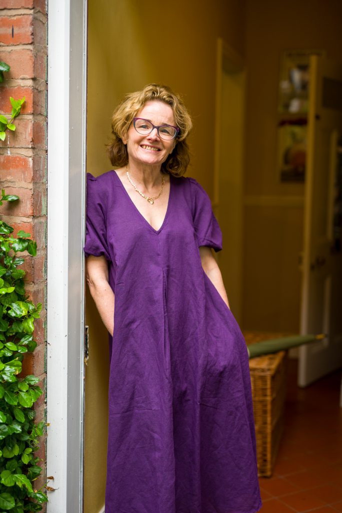 Ann Hill confidently stands outside her coaching space