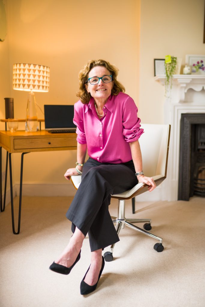 Ann Hill sits on her chair in her coaching space for women